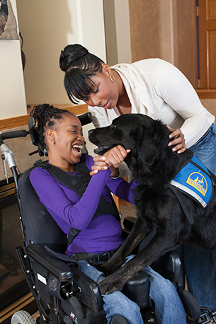 child and adult with Canine Companions service dog