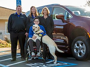 woman sitting in wheelchair with yellow Canine Companions Service Dog on her lap