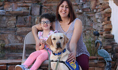 child and adult with Canine Companions service dog