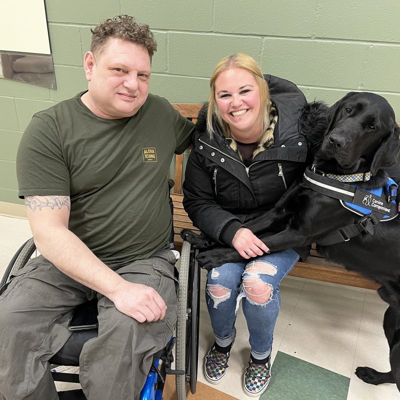 IMG_6293a Man and woman sitting together with service dog