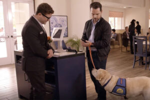 Man with service dog at restaurant counter