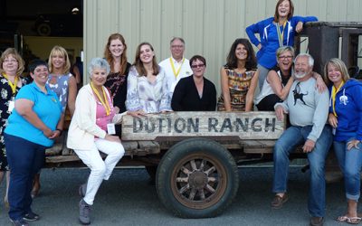 group of people sitting on an old truck