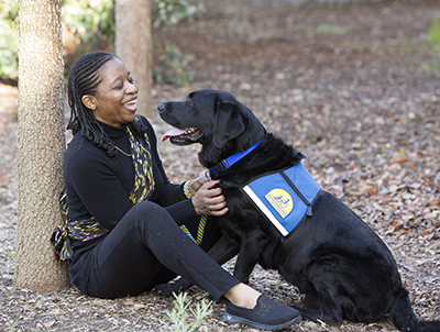 person sitting and looking at Canine Companions service dog