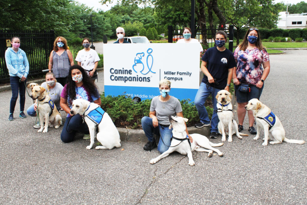 staff and dogs with new sign