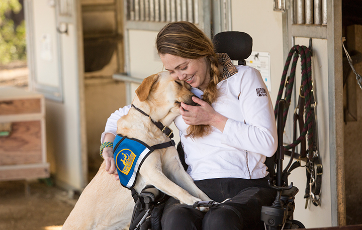 person hugging Canine Companions service dog