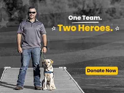 Veteran and service dog standing on a deck