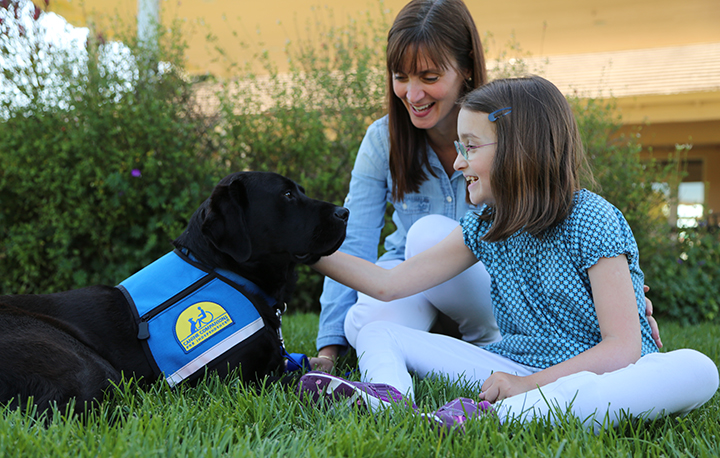child and adult with Canine Companions service dog